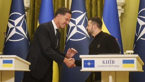 NATO Secretary General Mark Rutte, left, and Ukrainian President Volodymyr Zelenskyy, right, shake hands during press conference in Kyiv, Ukraine, Thursday, Oct. 3, 2024. (AP Photo/Evgeniy Maloletka)