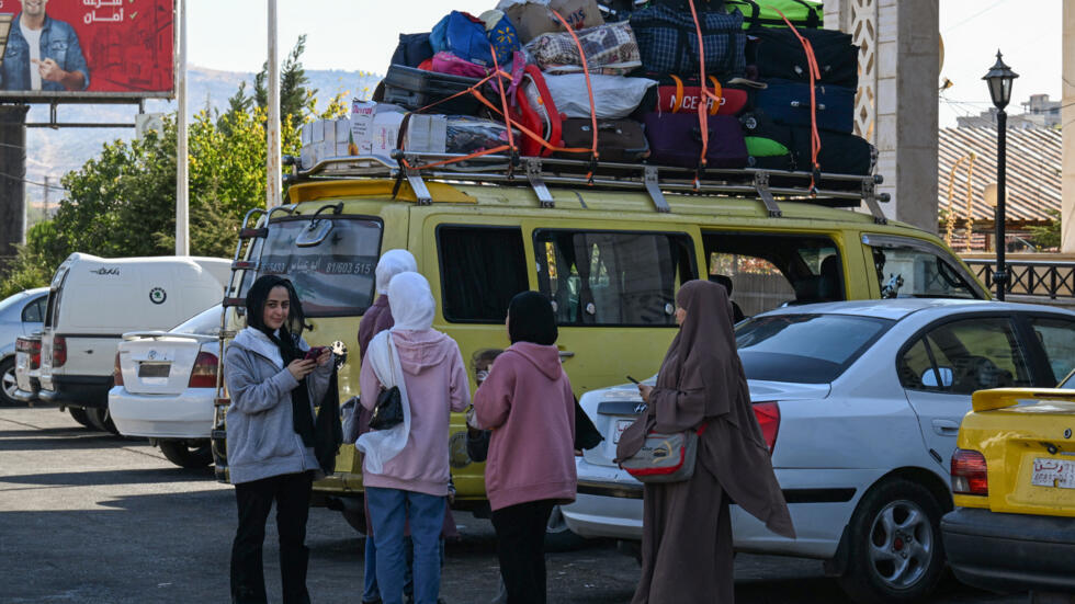 Travellers arrive from Lebanon at the Jdeidat Yabus border crossing in south-western Syria, on 7 October 2024. 