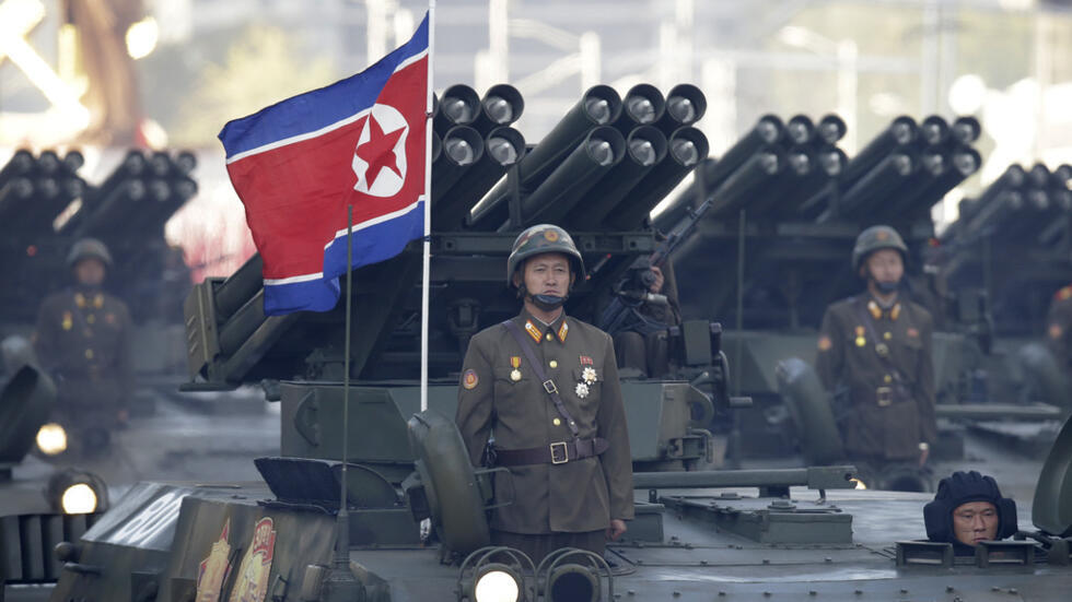 FILE - North Korean soldiers stand on armored vehicles with rocket launchers as they parade in Pyongyang, North Korea on Oct. 10, 2015. Hamas fighters likely used North Korean-manufactured rocket-prop