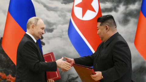 Russian President Vladimir Putin, left, and North Korea's leader Kim Jong Un exchange documents during a signing ceremony of the new partnership in Pyongyang, North Korea, on June 19, 2024.