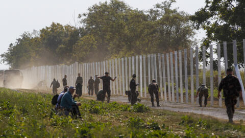 Hungarian soldiers work on a fence that is being built at the border with Croatia, near the village of Beremend, Hungary, on Sept. 22, 2015.