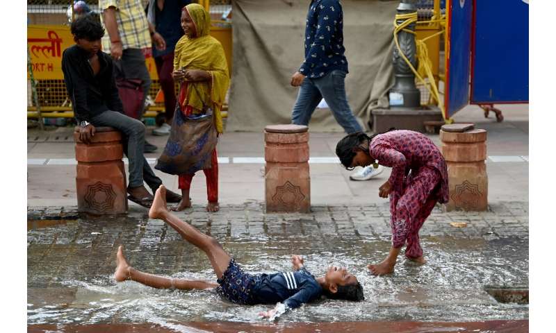 Children play after rainfall in the old quarters of Delhi on August 8. Monsoon rains across the region from June to September offer respite from the summer heat and are crucial to replenishing water supplies