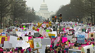 FILE - Demonstrators hold signs on Pennsylvania Avenue during the Women's March in Washington on Saturday, Jan. 19, 2019. (AP Photo/Jose Luis Magana)