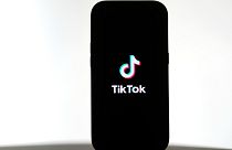 A TikTok logo is shown on a phone, Friday, January 17, 2025.