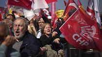 Supporters chant slogans while waving Turkish and CHP party flags during a rally protesting the arrest of Istanbul Mayor Ekrem Imamoglu