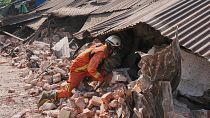 A rescuer works through rubble of a collapsed building following Friday's earthquake in Naypyitaw, Myanmar, Tuesday, April 1, 2025.