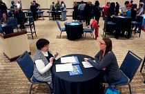 Fired IRS worker Brittany Glenn, right, talks to recruiter Lena Lager during a jobs fair for laid-off federal workers Saturday, March 15, 2025, in Kansas City, Mo. 