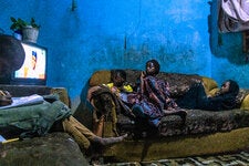 Often changing positions on the family sofa, the children cosy together to watch another episode of Gidan Badamasi, in Kano, Nigeria.