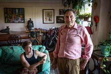 Jonathan Slon stands in the apartment that his grandmother first rented in 1938. His daughter, Maeve (seated), is part of the fifth generation to call the place home. 