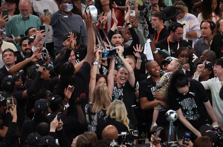 The New York Liberty celebrated with the W.N.B.A. championship trophy after defeating the Minnesota Lynx in Game 5 of the finals on Sunday in New York.