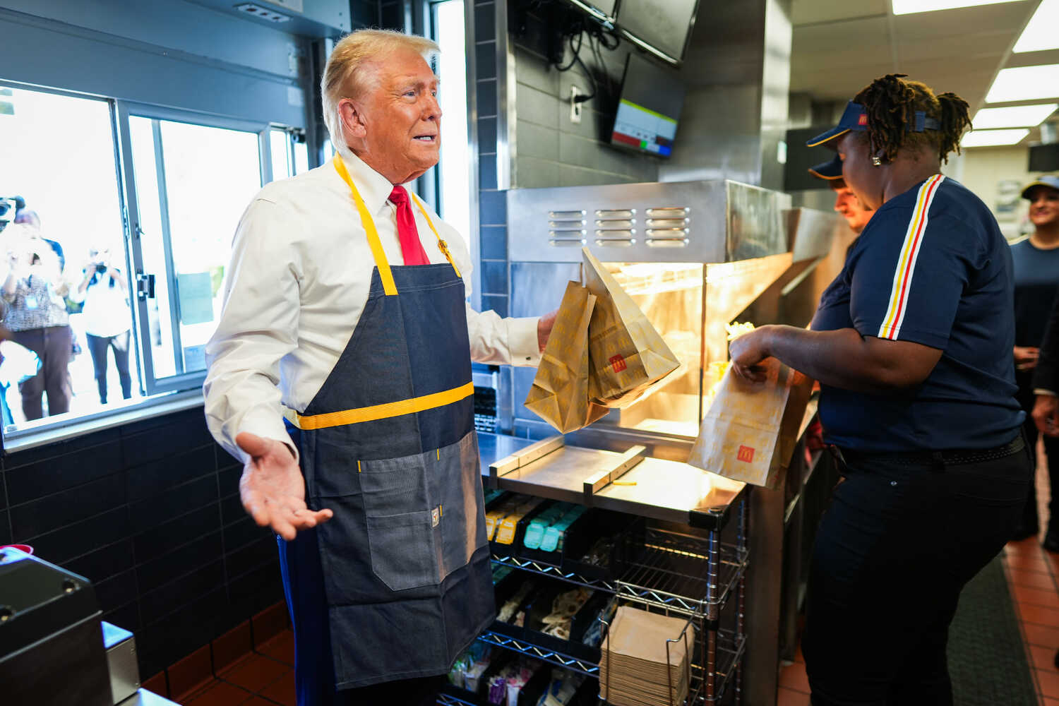 Former President Donald J. Trump served French fries at a McDonald’s in Feasterville, Pa., on Sunday. Some workers who watched footage of his performance said he did not behave quite like a model employee.