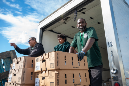 Volunteers and staff distribute food during a St. Joseph Center community outreach event
