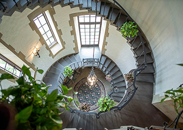 light gray spiral staircase and windows 
