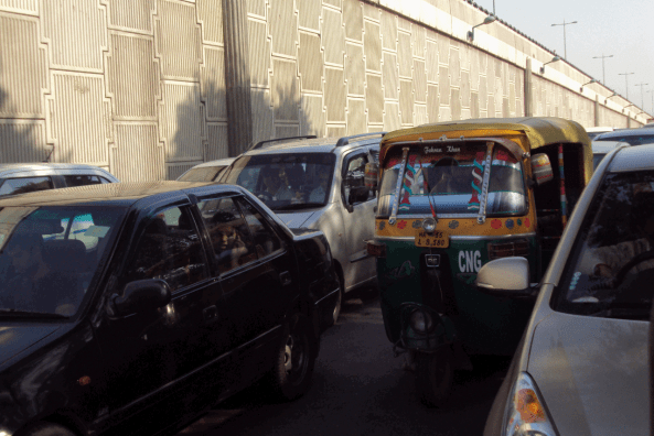 Waiting at the crossing - Road shared by the rich and the poor