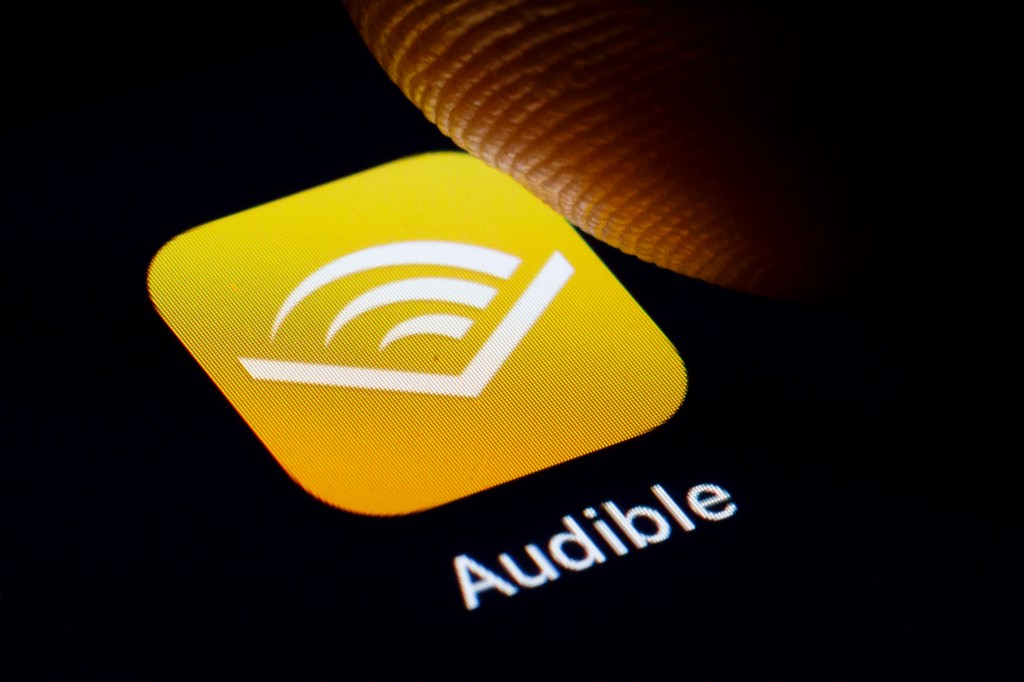 In this photo illustration the logo of Amazon Audible is displayed on a smartphone