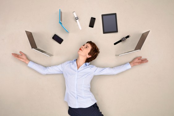 Woman juggling smartphones, tablets and smart watches, used in a post about Respond.io