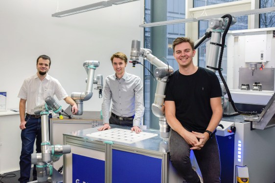 Robco team in lab with robotic devices