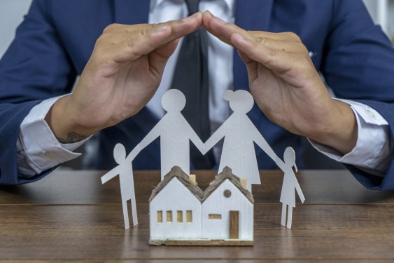 Insurer protecting a paper cut outfamily with his hand, used in post about PasarPolis