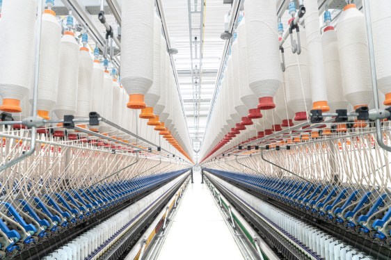 Spools of yarn on a spinning machine seen at the wool manufacturing facility