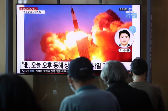 people watching a TV at the Seoul Railway Station showing a file image of a North Korean missile launch, on September 15, 2021 in Seoul, South Korea