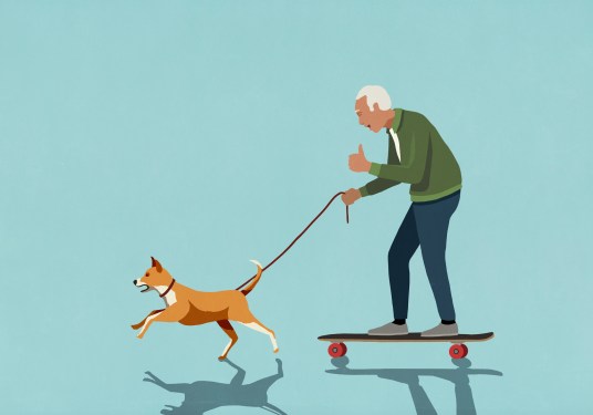 Dog on leash pulling excited senior man on skateboard