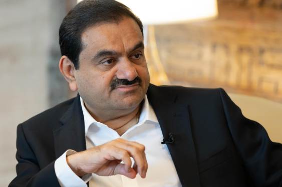 Gautam Adani, chairman of Adani Group, sits during a television interview.