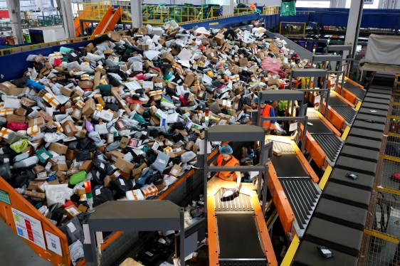 Staff sort express deliveries at the network operation center of the delivery division of China Post Group's Zaozhuang branch.