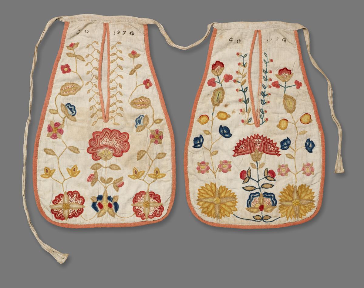 Pocket 1720-1740, linen, front of ribbed weave, backed w plain linen, back of coarse linen; wool embroidery, bound with pink woollen braid, MFA Boston 1951_107_2