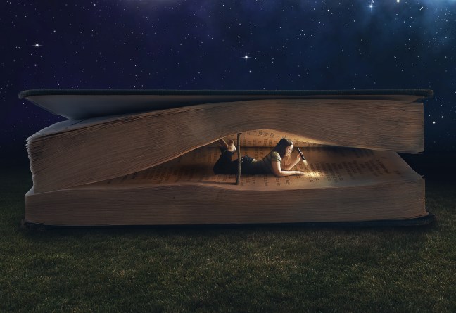 Woman reading inside a huge book