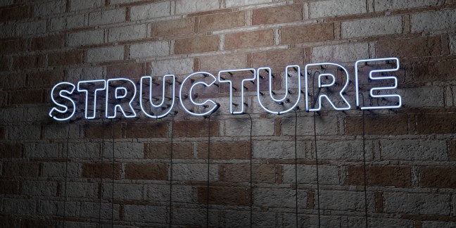 STRUCTURE - Glowing Neon Sign on stonework wall