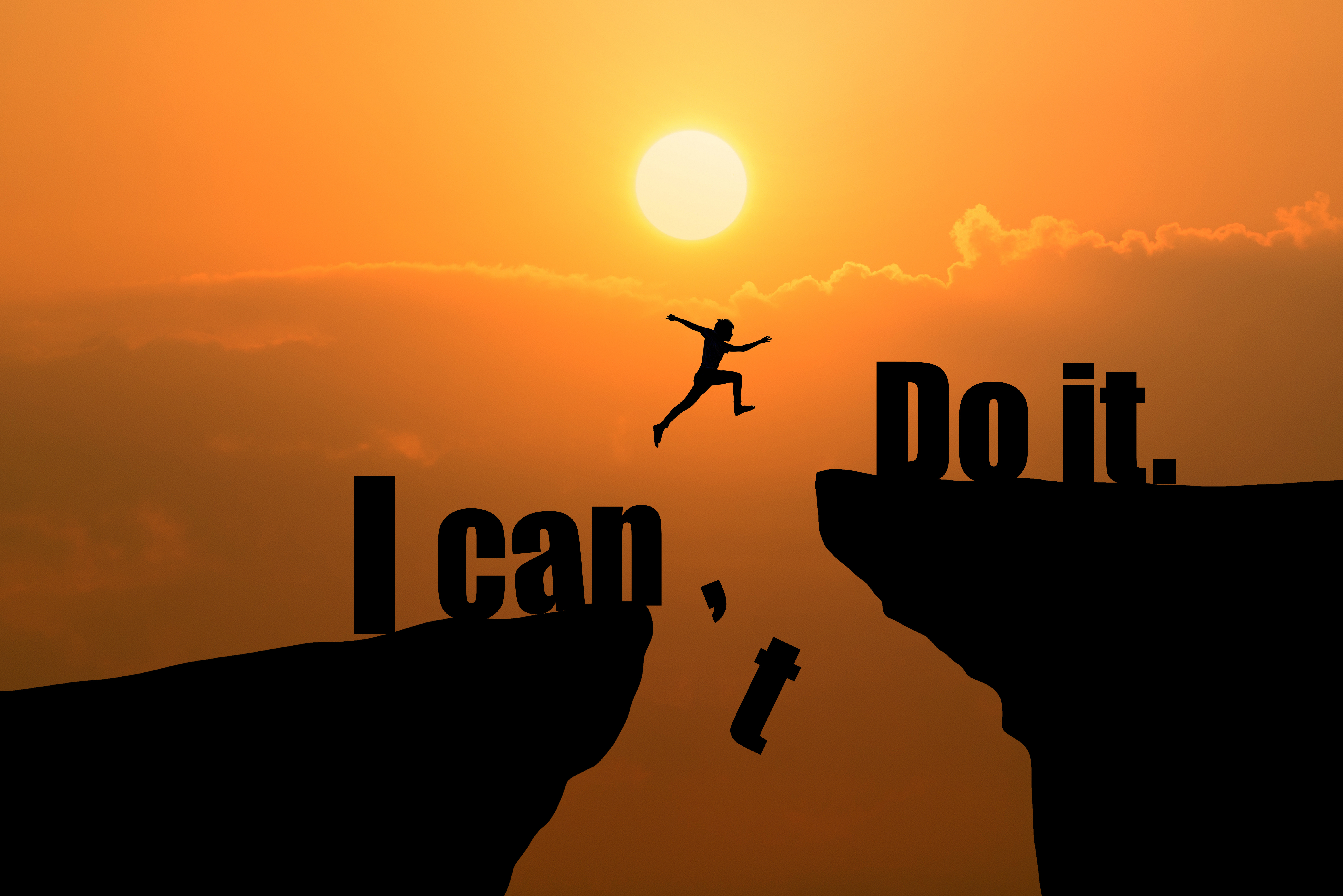 Man jumping on I can do it or I can't do it text over cliff on sunset background