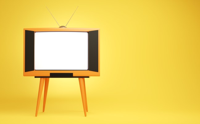 Retro orange tv receiver on the yellow background.