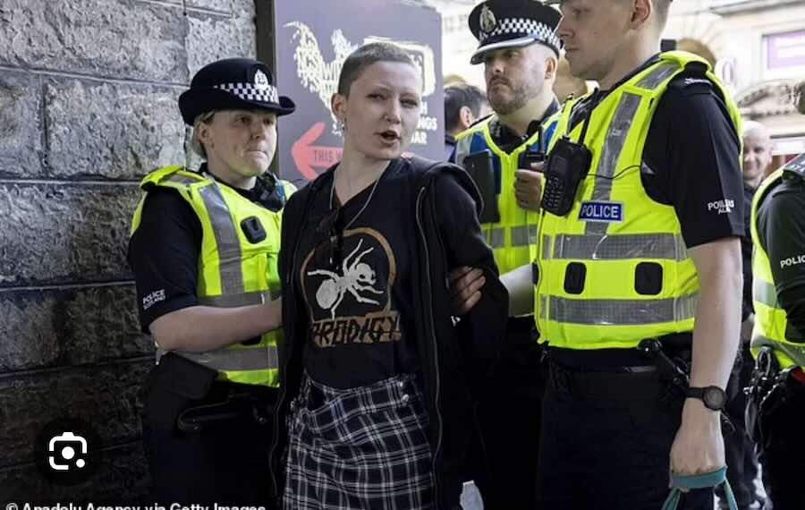 Defiant woman restrained by three police officers