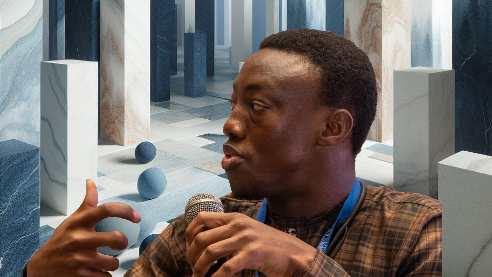 A man speaking into a microphone in front of a blue background.