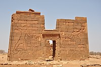 Temple of Apedemak in Naqa. Pylons depicting King Natakamani and Queen Amanitore smiting enemies. The queen holds a sword, the king an axe.[14]