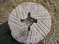 A grave marker in Douglas County, Kansas, USA, resembling a millstone.