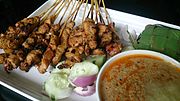 Satay with peanut sauce, onions and cucumber