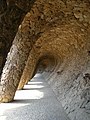 Colonnaded pathway where the road projects out from the hillside, with the vaulting forming a retaining wall which curves over to support the road, and transmits the load onto sloping columns.