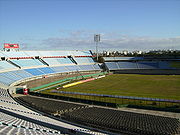 Large football pitch, with surrounding grandstands