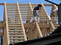 A steeply pitched, timber framed roof under construction in Japan