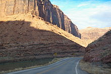 Highway and river following a curvy, sandstone gorge