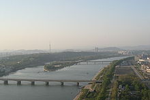 scenic photo of a river as it passes through a city