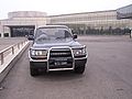 A right-hand-drive Toyota Landcruiser in front of a Pyongyang hotel