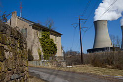 An abandoned house in Fricks Locks Historic District (foreground) and Limerick Generating Station (background)