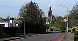 Médoclaan naar het westen met zicht op de kerk van Wolder