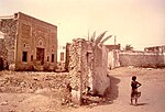 Partially ruined stone building with a decorated facade.