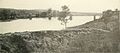 View of Stafford Heights across the Rappahannock River from Fredericksburg from Confederate-built trenches used during the Battle of Fredericksburg in 1862. Union army encampments are seen on the heights and a pontoon bridge is seen further down river from the destroyed bridge.