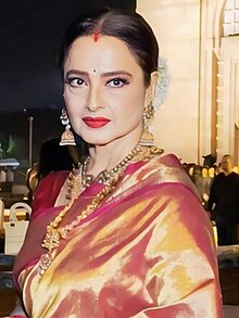 Rekha is looking at the camera.