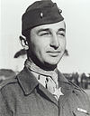 man in Marine uniform with cap, medal around neck