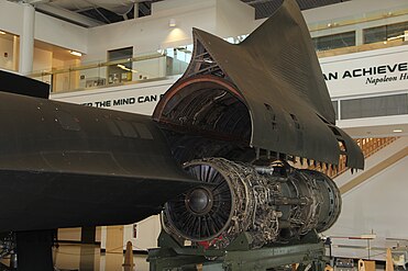 The inlet at left was depressed when the engine ran at high power settings with inadequate inlet ram (stationary and low flight speeds). The lower-than-ambient pressure in the inlet brought in extra air through the spike bleed and forward bypass louvers shown on the inlet external surface. Adequate secondary cooling air came in through the suck-in doors (shown open on the hinged nacelle).